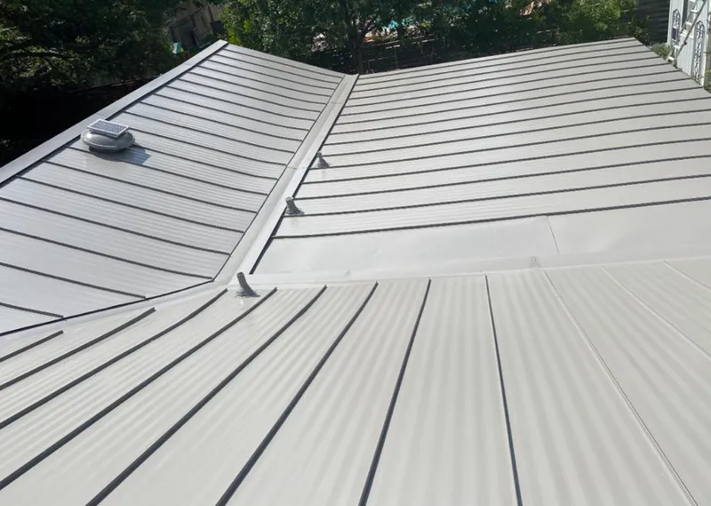 Solar attic fan installed on a metal roof for Roof Ventilation in Florida City